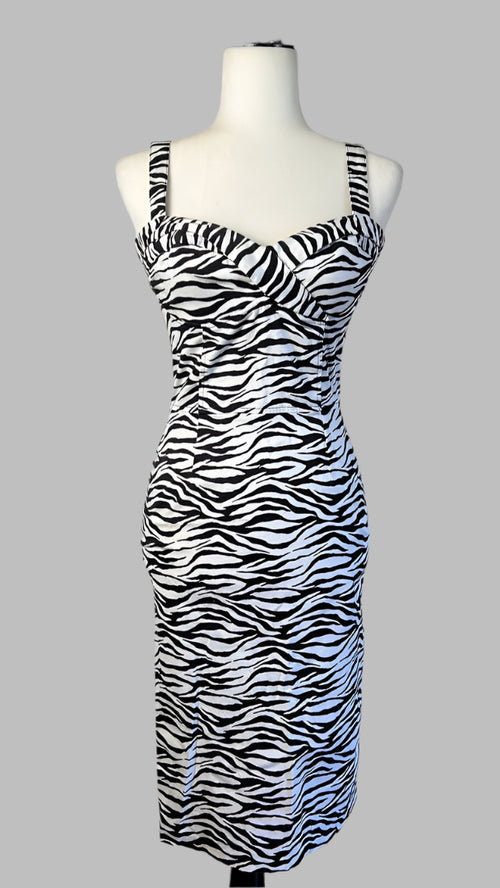 Zebra print dress on a mannequin against a white wall.