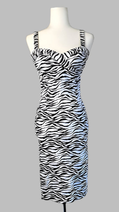 Zebra print dress on a mannequin against a white wall.
